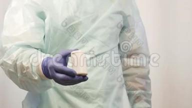 戴着医用手套的男医生的手从罐子里取出药丸，这是病人必须服用的。